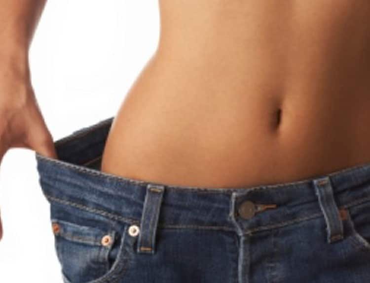woman in loose jeans weight loss