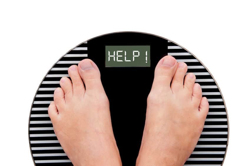 Word help written on a weight scale isolated on white background